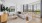 living room with a couch coffee table tv and large windows