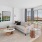 living room with a couch coffee table tv and large windows