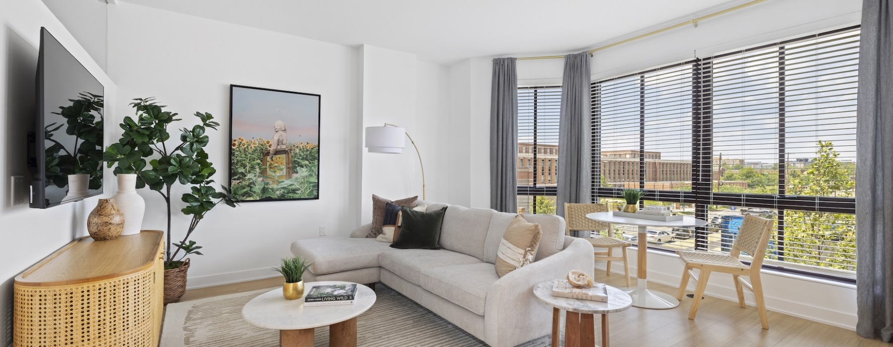 Living room with floor to ceiling windows and soft seating 