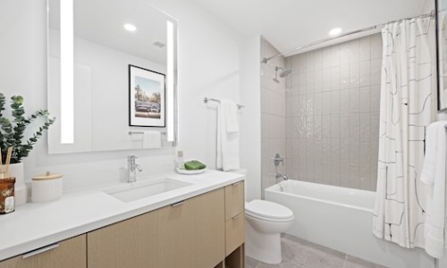 bathroom showing a tub, modern fixtures and wood-style flooring bathroom showing a tub, modern fixtures and wood-style flooring