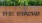 a sign with bushes above it