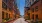a brick walkway between buildings at dusk