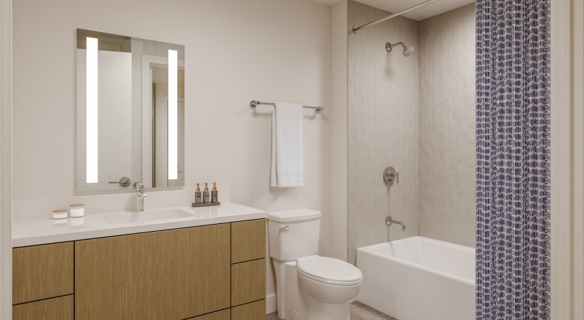 bathroom showing a tub, modern fixtures and wood-style flooring